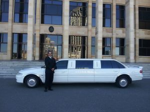 man standing near white limo